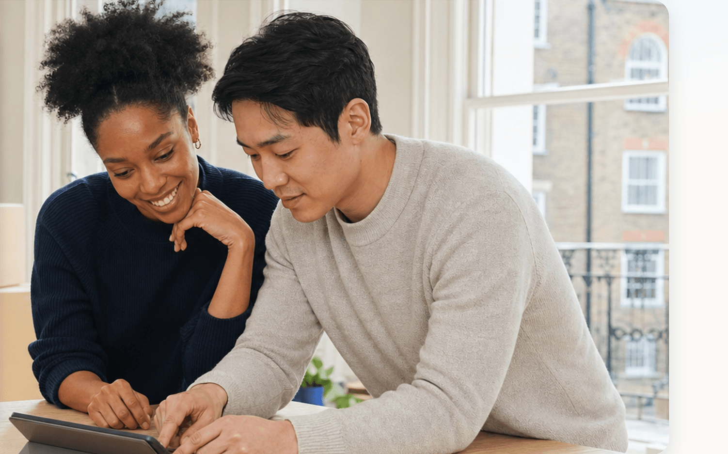 Couple reviewing their few-items move on a tablet